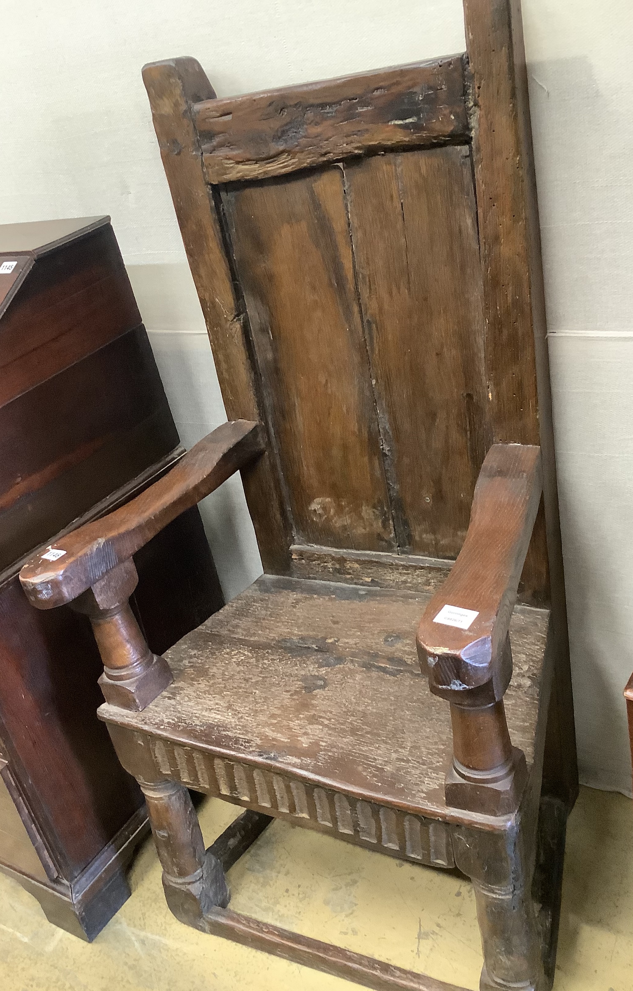 A 17th century oak panelled back armchair
